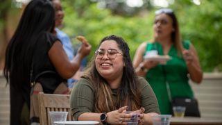 A smiling student sitting at a table